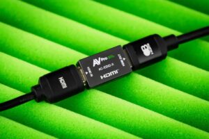 AVPro Edge AC-EDID-X inline between two HDMI cables on green foam